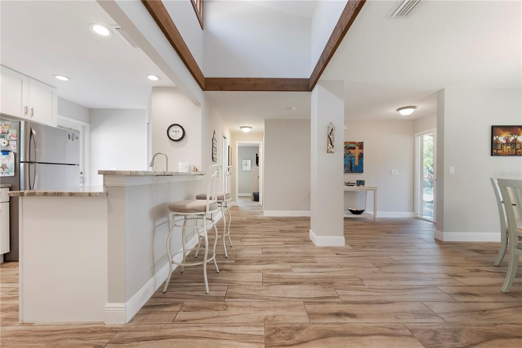 3804 Sun Eagle Lane Bradenton, FL 34210 - Photo 8 of 55 a kitchen with stainless steel appliances kitchen island granite countertop a refrigerator and a stove