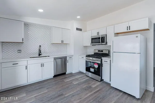 a kitchen with a refrigerator stove and sink