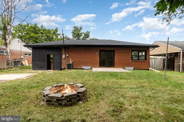 a backyard of a house with table and chairs