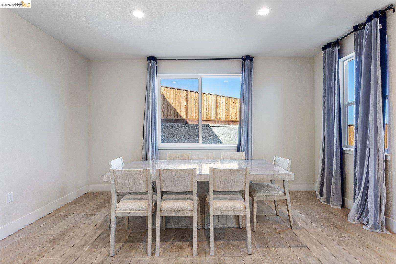 5601 Ridgepoint Way Antioch, CA 94531 - Photo 17 of 59 Dining space featuring wood-finish flooring, two large windows, white baseboards, and recessed lighting