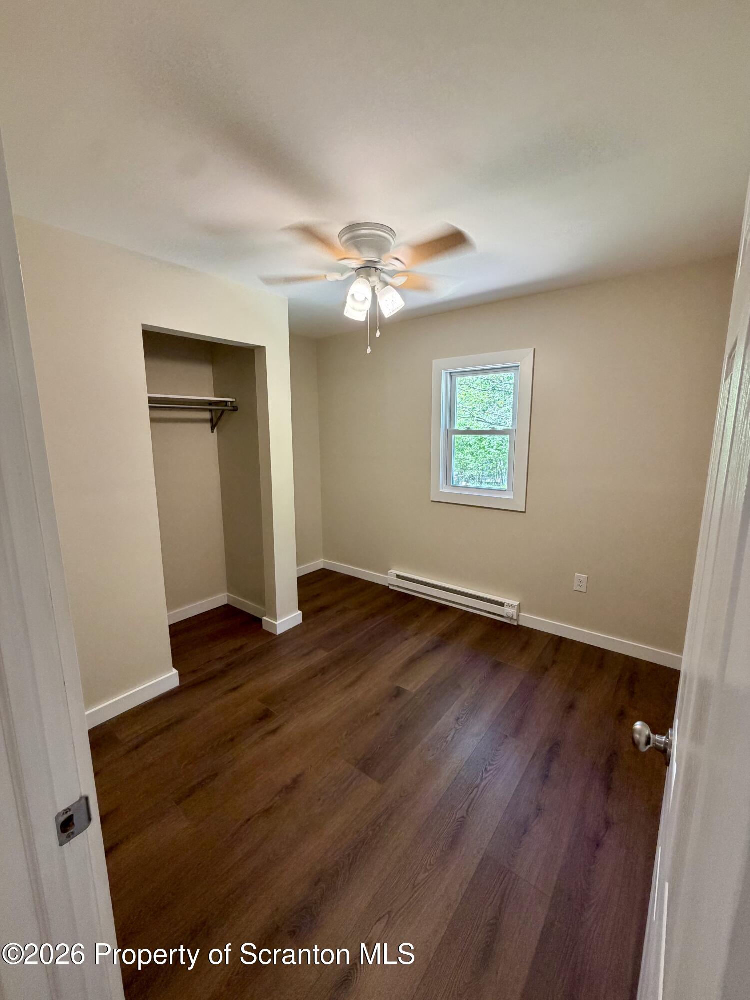 2139 Fawn Path Gouldsboro, PA 18424 - Photo 8 of 9 an empty room with wooden floor chandelier fan and windows