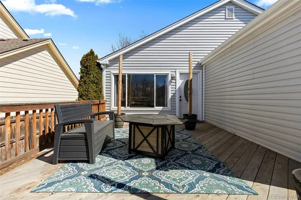a backyard of a house with barbeque oven table and chairs