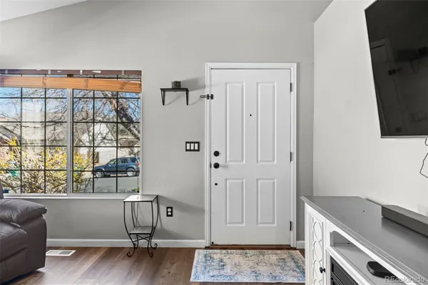 a view of a livingroom with an empty space and a window