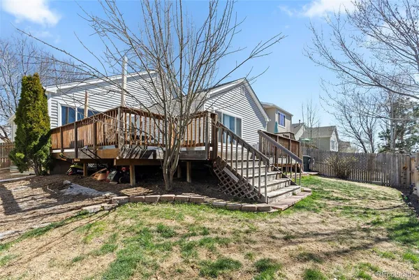 a view of a house with wooden fence