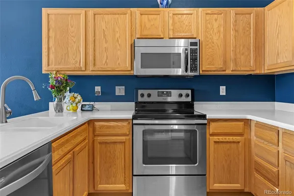 a kitchen with stainless steel appliances granite countertop cabinets and a microwave oven