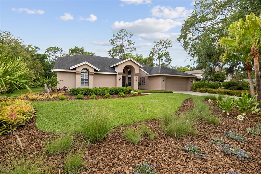 3372 Brian Road South Palm Harbor, FL 34685 - Photo 4 of 45 a front view of a house with garden