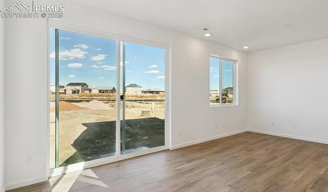 an empty room with sliding glass door and glass door