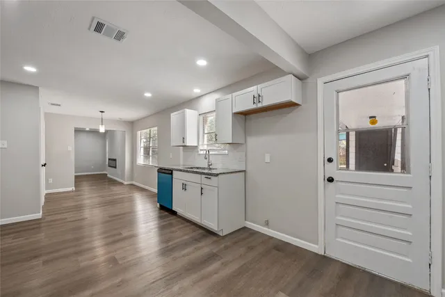 a view of a kitchen with a sink and cabinets