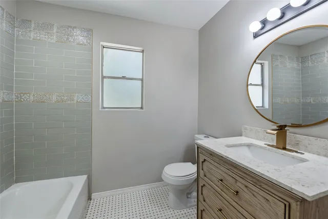 a bathroom with a sink a toilet and a mirror