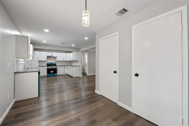 a view of kitchen with kitchen island and stainless steel appliances