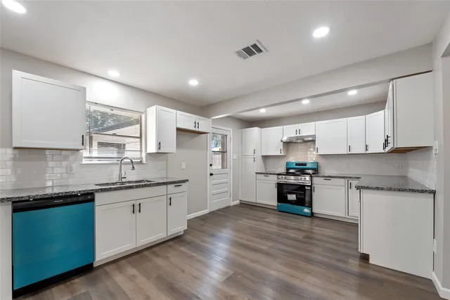a kitchen with stainless steel appliances granite countertop refrigerator sink and cabinets