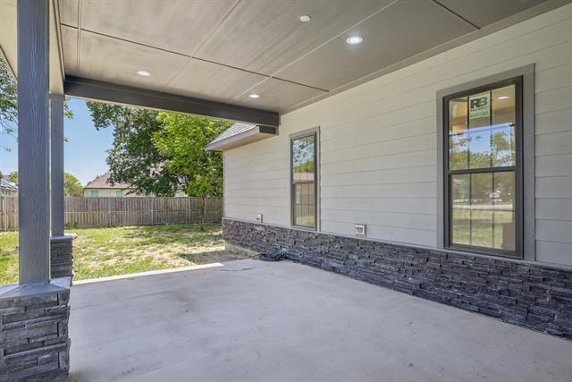 2936 Henry Road Lancaster, TX 75134 - Photo 27 of 28 Covered concrete patio with recessed lighting, shiplap siding, and a stone veneer foundation accent