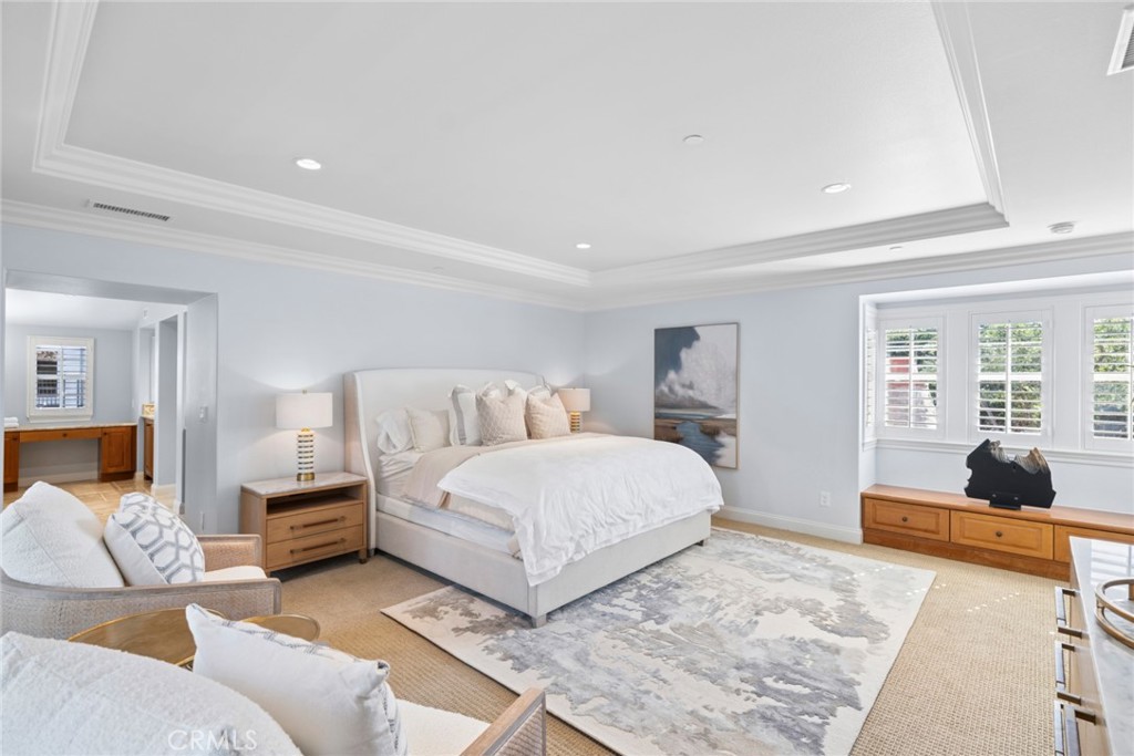 2 Ali Lane Ladera Ranch, CA 92694 - Photo 31 of 75 The primary suite offers a sitting area, viewing deck, elegant tray ceiling w/ crown molding, oversized custom walk-in closet & spa-inspired bath w/dual vanities, soaking tub, frameless glass shower & refined finishes