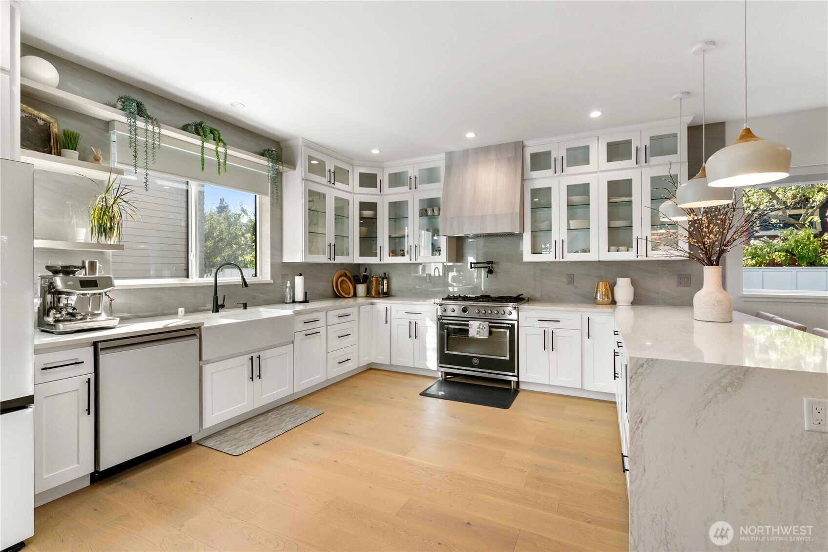 509 North 78th Street Seattle, WA 98103 - Photo 11 of 37 a large kitchen with stainless steel appliances granite countertop a stove and a sink