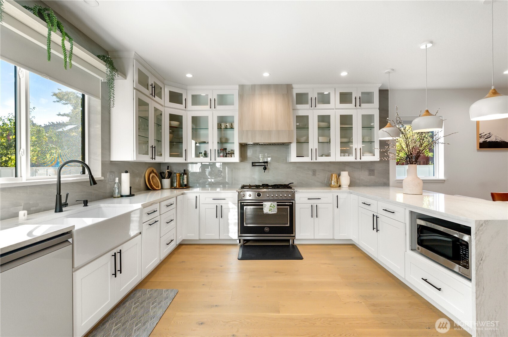 509 North 78th Street Seattle, WA 98103 - Photo 12 of 37 a large kitchen with stainless steel appliances granite countertop a stove sink and cabinets