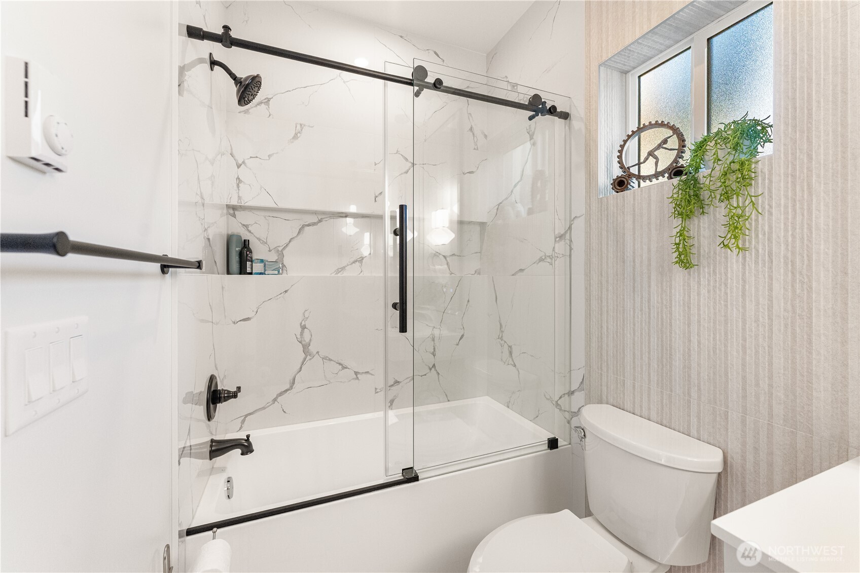 509 North 78th Street Seattle, WA 98103 - Photo 17 of 37 a bathroom with a shower and toilet