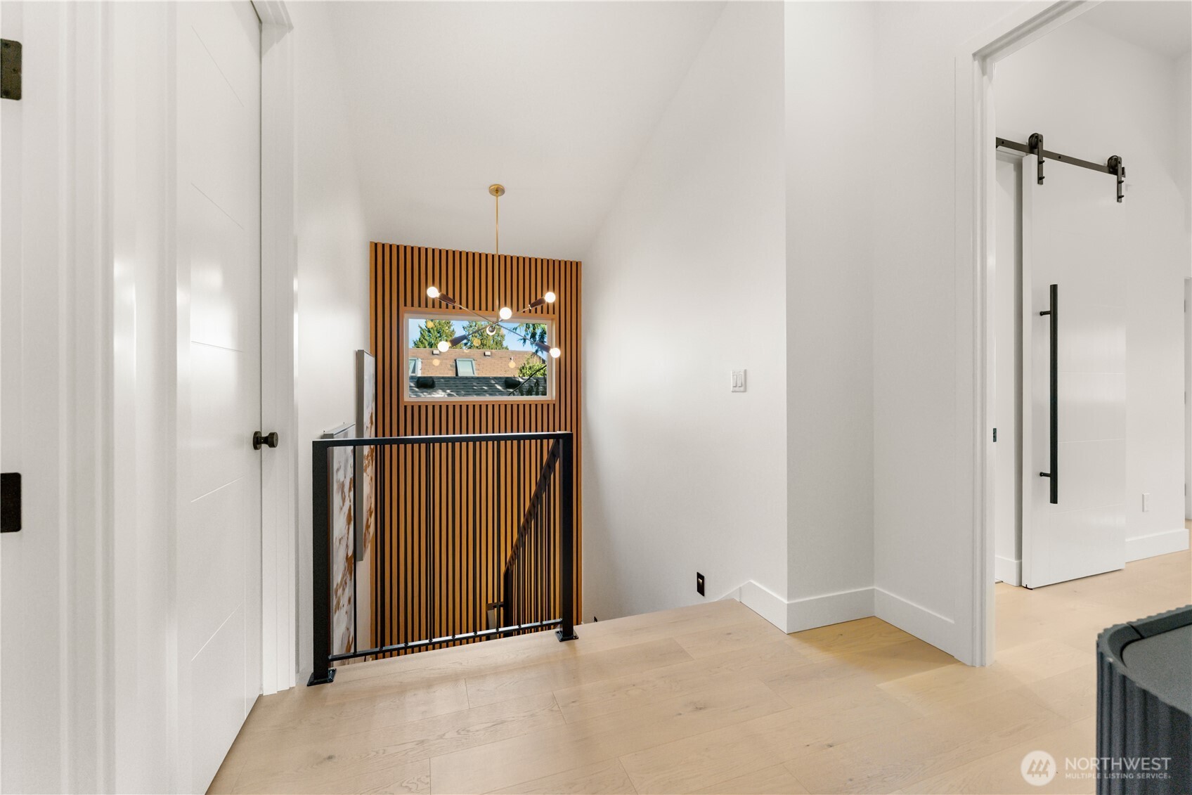 509 North 78th Street Seattle, WA 98103 - Photo 18 of 37 a view of a hallway with wooden floor and windows