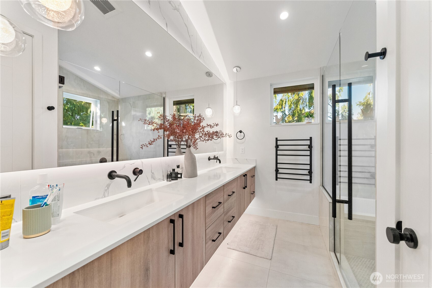 509 North 78th Street Seattle, WA 98103 - Photo 25 of 37 a spacious bathroom with a double vanity sink and a mirror