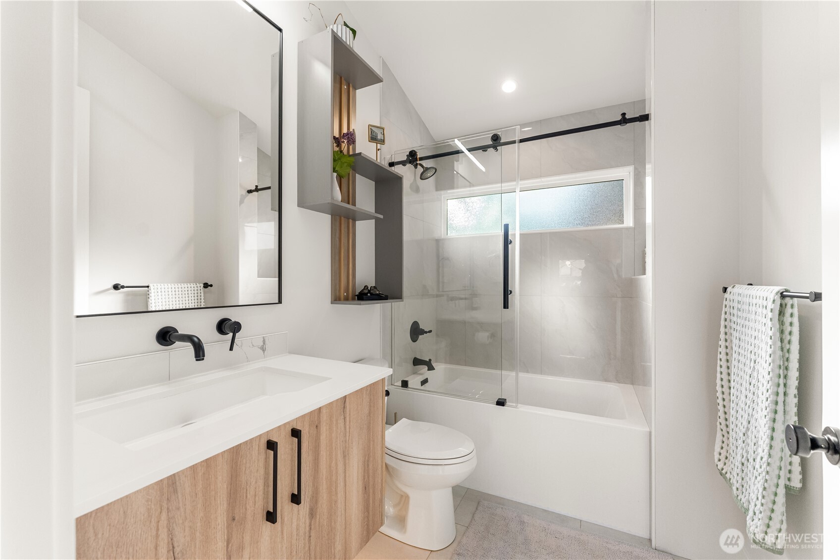 509 North 78th Street Seattle, WA 98103 - Photo 30 of 37 a bathroom with a sink a toilet and shower