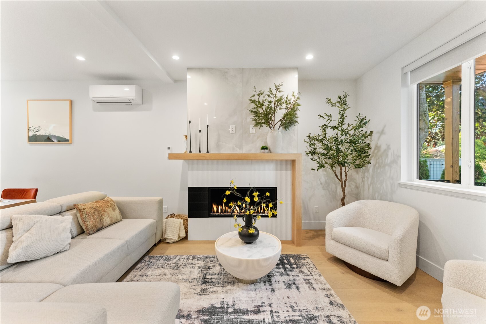 509 North 78th Street Seattle, WA 98103 - Photo 6 of 37 a living room with furniture a fireplace and a large mirror