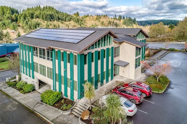 an aerial view of a house with a garden and outdoor seating