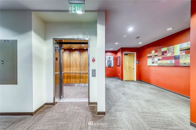 a living room with furniture pool table and stainless steel appliances
