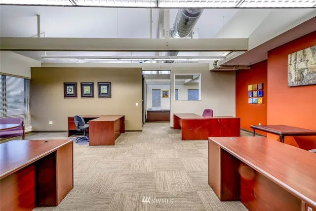 a work room with furniture and windows