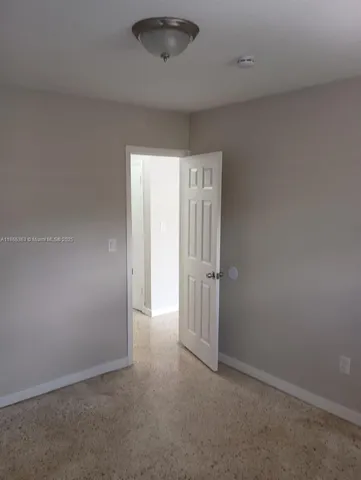 an empty room with a empty space and windows