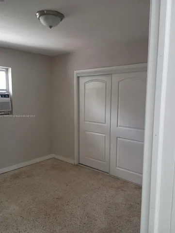 an empty room with closet area