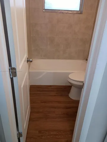 a bathroom with a bathtub and toilet