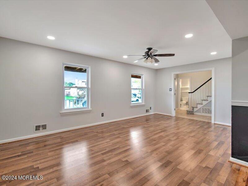 38 Starlight Road Howell, NJ 07731 - Photo 11 of 49 an empty room with wooden floor and windows