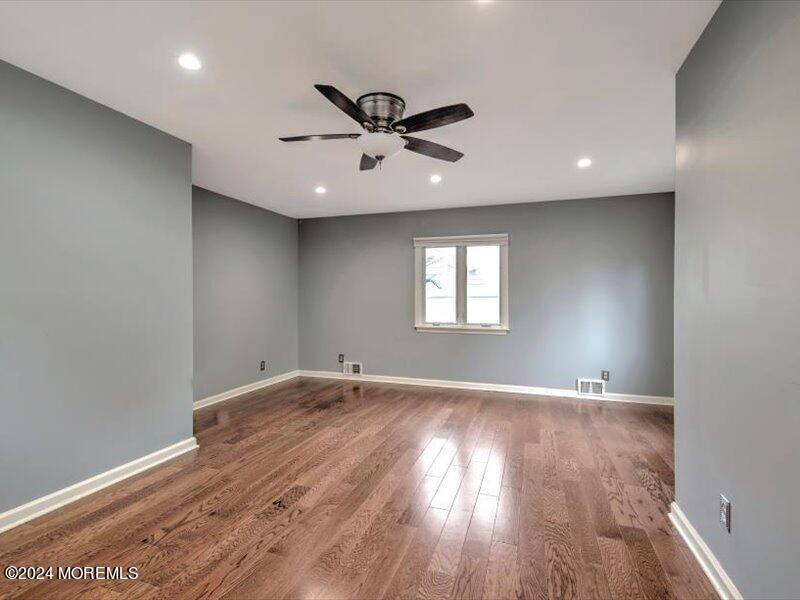 38 Starlight Road Howell, NJ 07731 - Photo 14 of 49 an empty room with wooden floor and windows