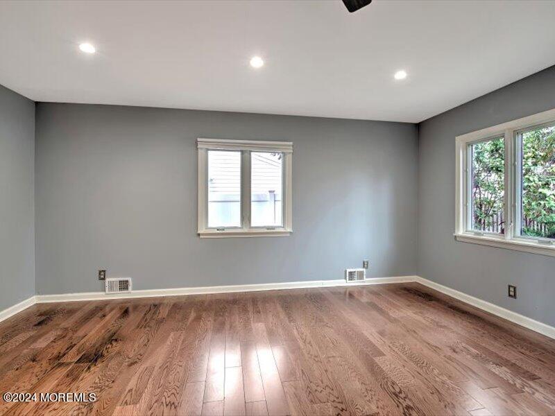38 Starlight Road Howell, NJ 07731 - Photo 15 of 49 an empty room with wooden floor and windows