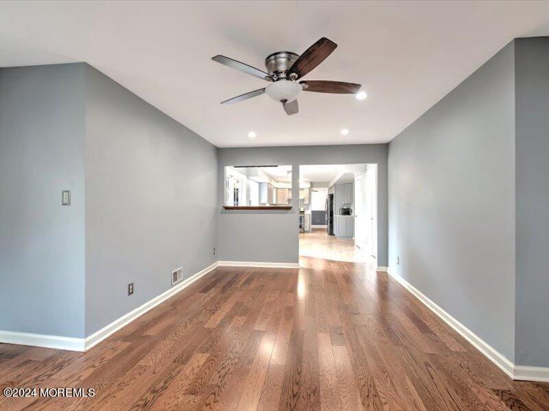 38 Starlight Road Howell, NJ 07731 - Photo 18 of 49 a view of a livingroom with a ceiling fan and wooden floor