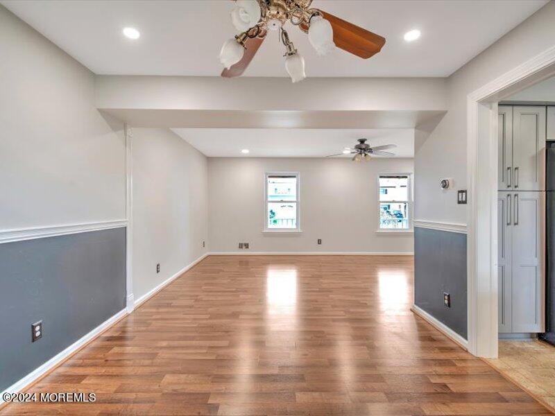 38 Starlight Road Howell, NJ 07731 - Photo 19 of 49 an empty room with wooden floor and cabinet