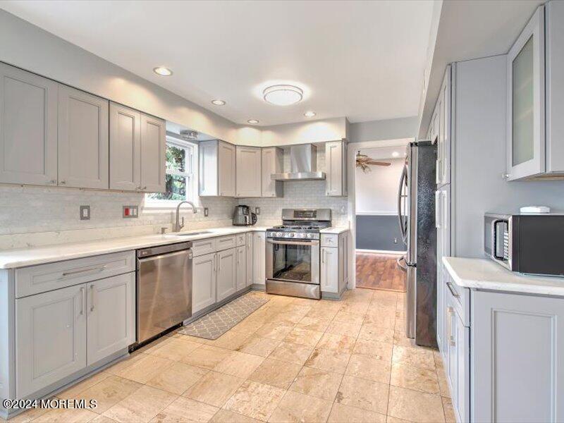 38 Starlight Road Howell, NJ 07731 - Photo 21 of 49 a kitchen with a sink a counter top space stainless steel appliances and cabinets