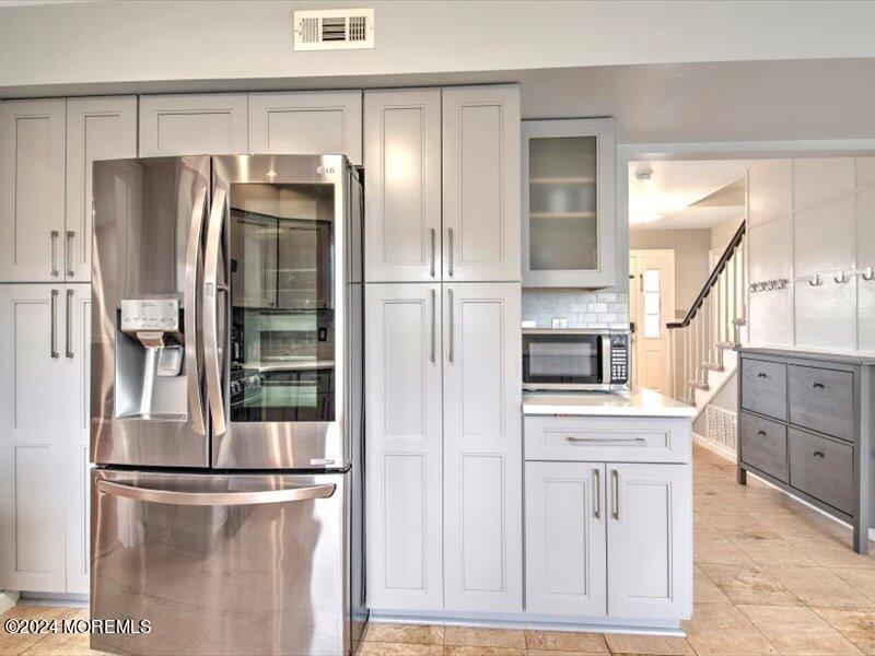 38 Starlight Road Howell, NJ 07731 - Photo 24 of 49 a kitchen with stainless steel appliances refrigerator and cabinets