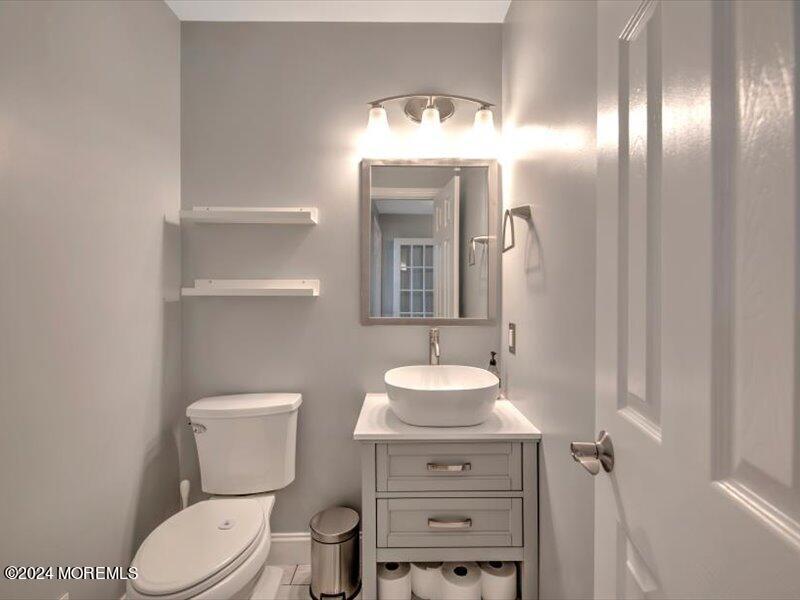 38 Starlight Road Howell, NJ 07731 - Photo 28 of 49 a bathroom with a toilet sink and mirror