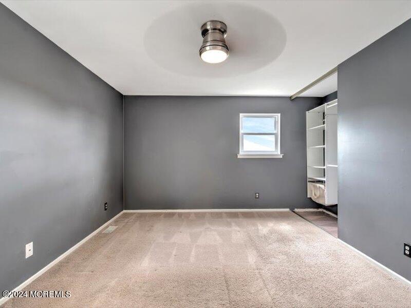 38 Starlight Road Howell, NJ 07731 - Photo 29 of 49 an empty room with windows and cabinet