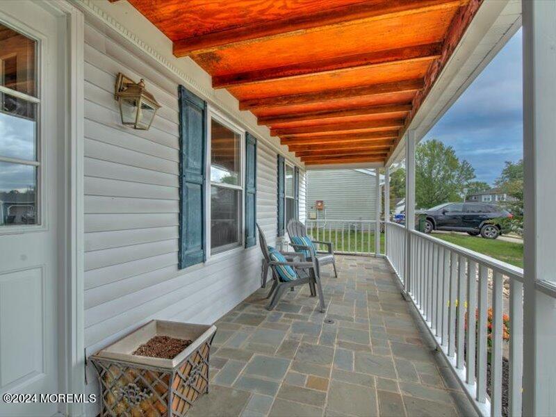 38 Starlight Road Howell, NJ 07731 - Photo 3 of 49 a view of a patio with table and chairs and wooden floor