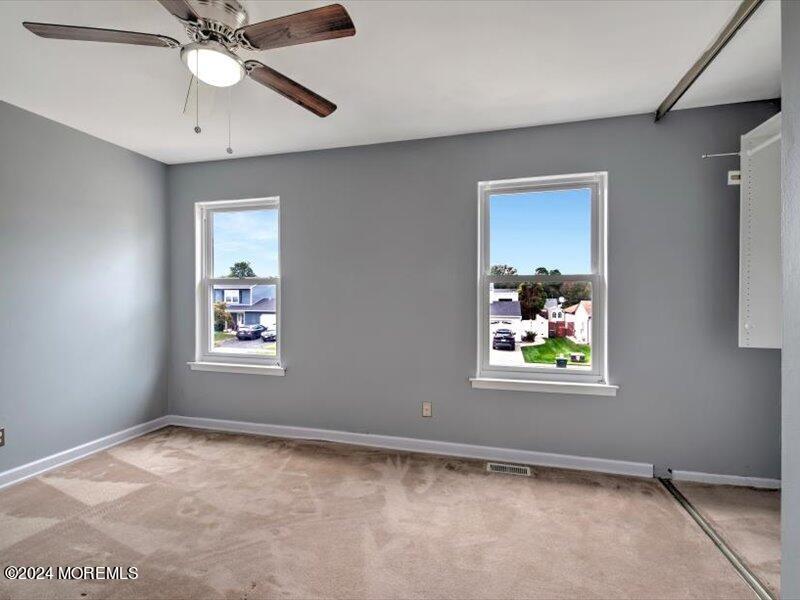 38 Starlight Road Howell, NJ 07731 - Photo 33 of 49 a view of an empty room with window and wooden floor