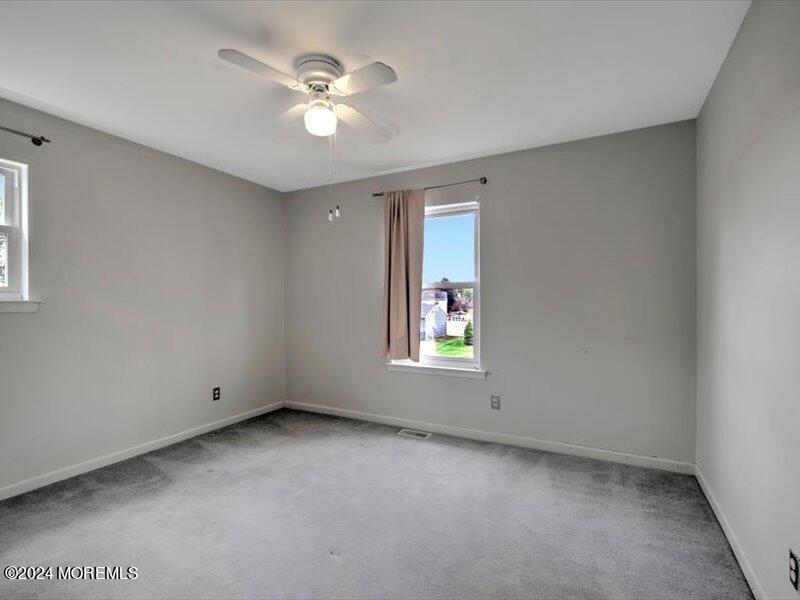 38 Starlight Road Howell, NJ 07731 - Photo 35 of 49 an empty room with windows and ceiling fan