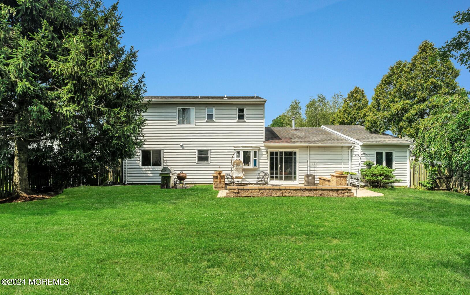 38 Starlight Road Howell, NJ 07731 - Photo 4 of 49 a front view of a house with a garden and trees