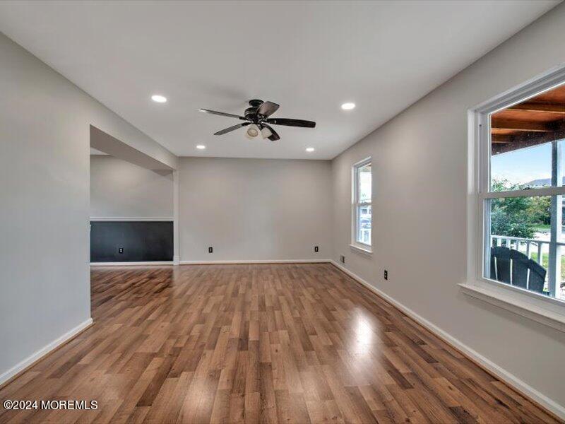 38 Starlight Road Howell, NJ 07731 - Photo 9 of 49 a view of an empty room with a window and wooden floor