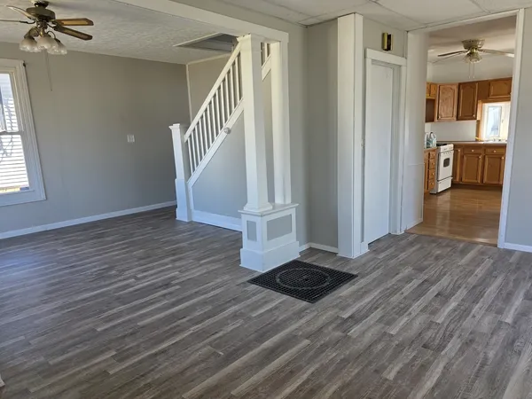 a view of a hallway view with wooden floor and staircase