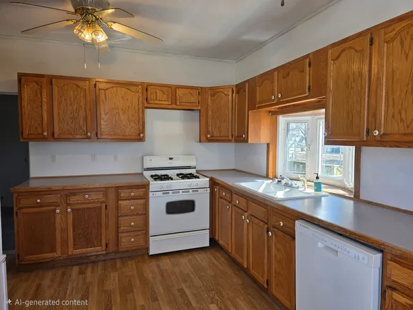 a kitchen with stainless steel appliances granite countertop a stove a sink dishwasher and a microwave oven with cabinets