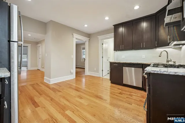 a view of kitchen with cabinets and wooden floor