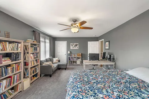 a living room with a couch and a book shelf