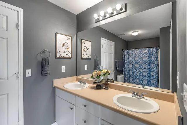 a bathroom with a sink double vanity and a mirror