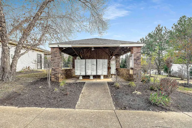 a view of a patio with a table and chairs under an umbrella